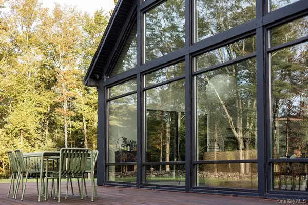 a view of house with outdoor space and sitting area