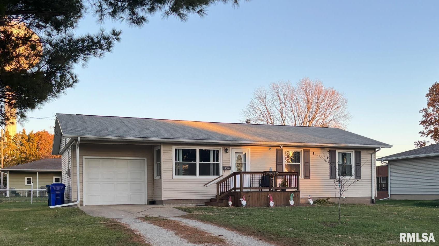 a front view of a house with a yard table and chairs