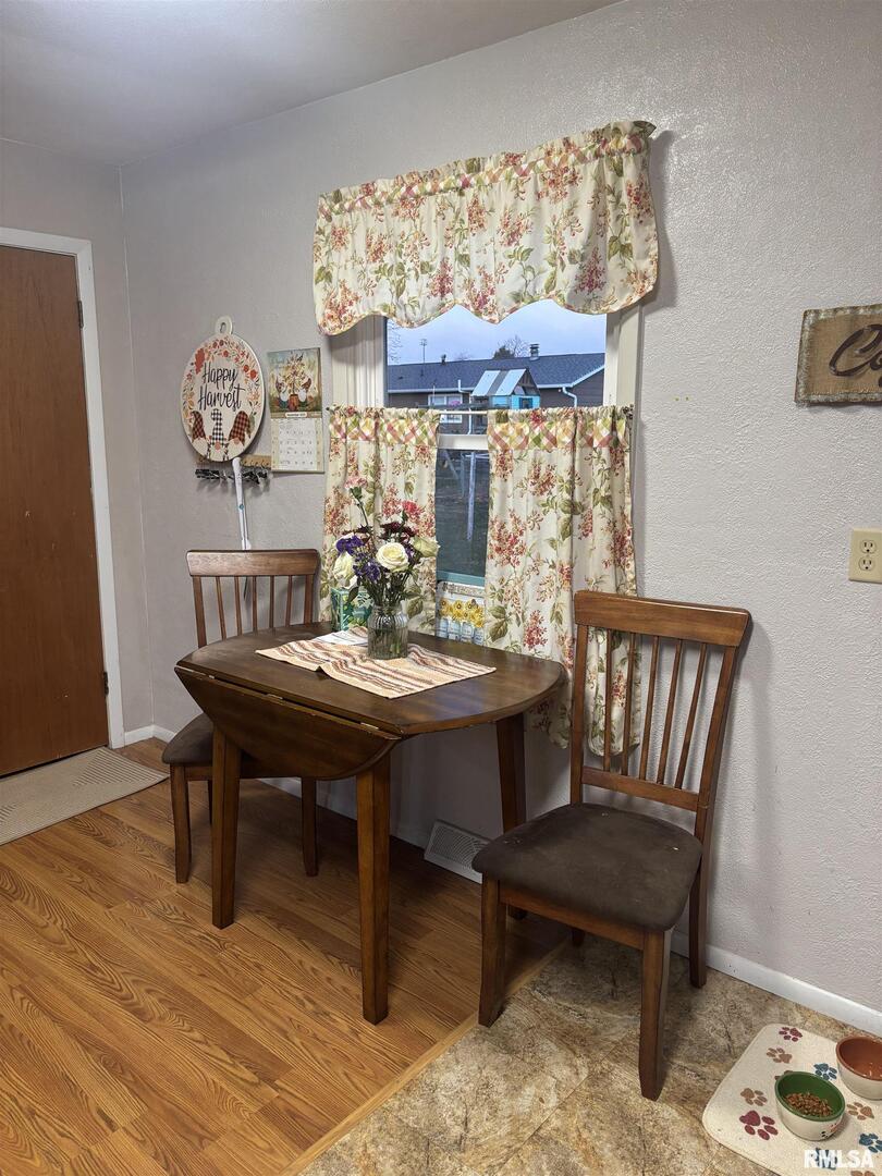 434 Payson Street Kewanee, IL 61443 - Photo 16 of 38 a view of a dining room with furniture one side kitchen view and wooden floor