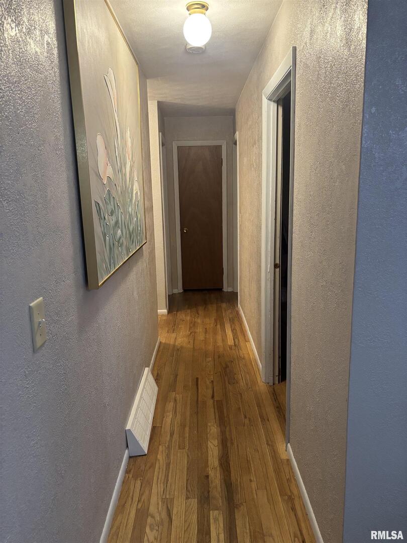 434 Payson Street Kewanee, IL 61443 - Photo 18 of 38 a view of a hallway with wooden floor and a bathroom