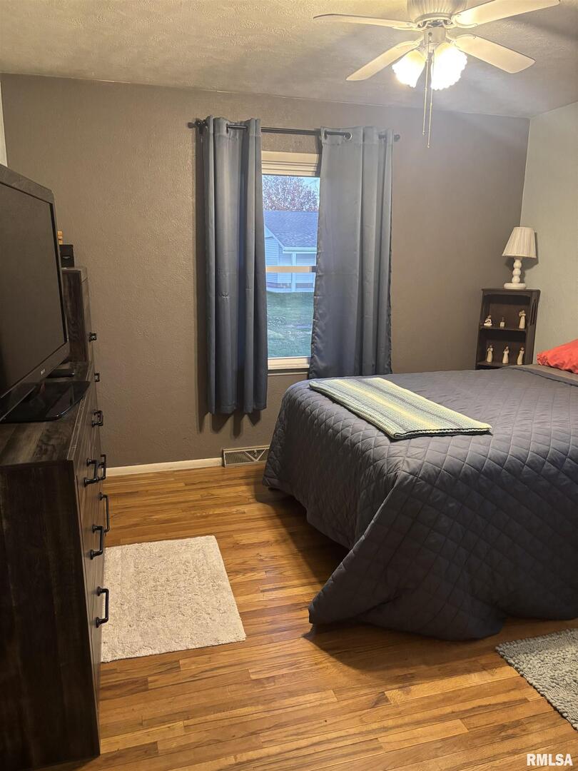 434 Payson Street Kewanee, IL 61443 - Photo 19 of 38 a bedroom with a bed and a chandelier