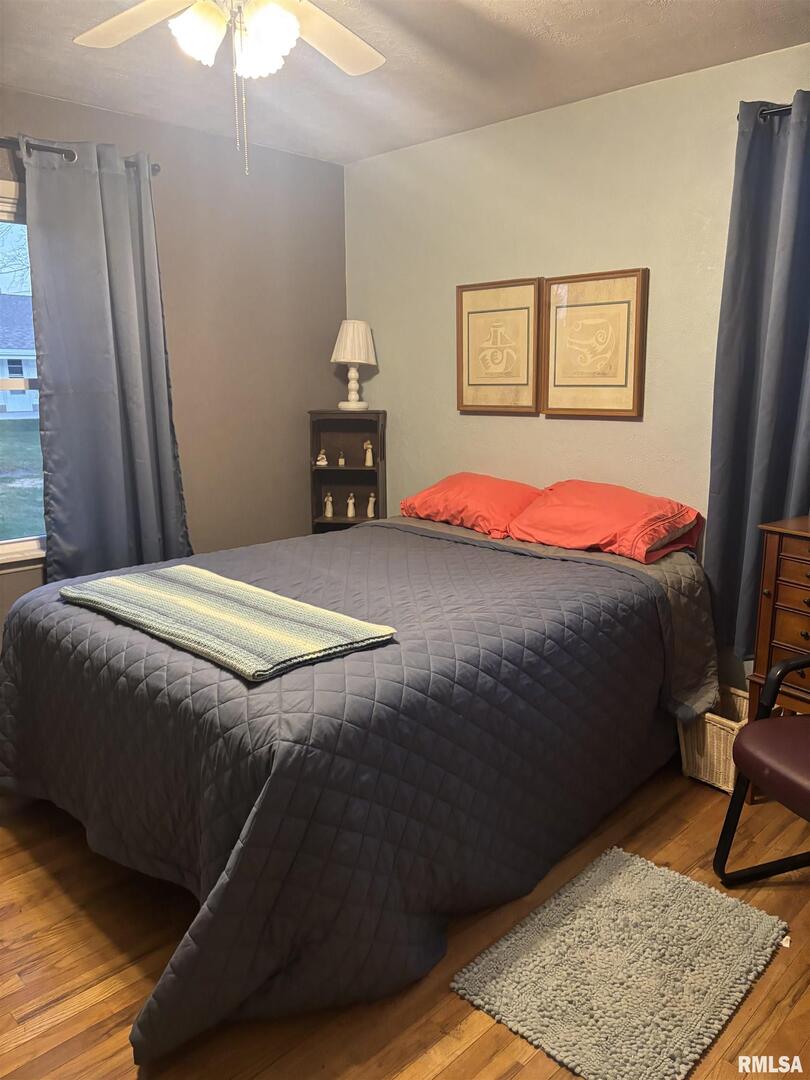 434 Payson Street Kewanee, IL 61443 - Photo 20 of 38 a bedroom with a bed and wooden floor