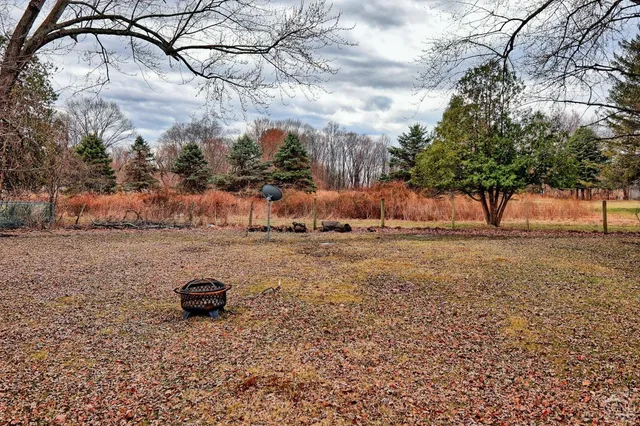 a view of a house with a patio and a yard