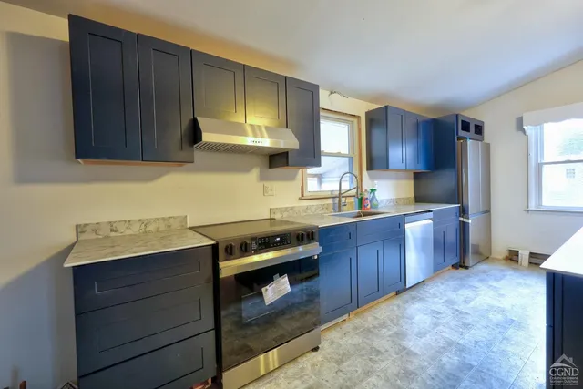 a kitchen with kitchen island granite countertop wooden cabinets a sink and dishwasher
