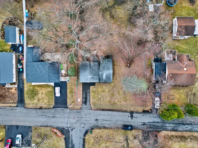 a view of a house with a yard and sitting area