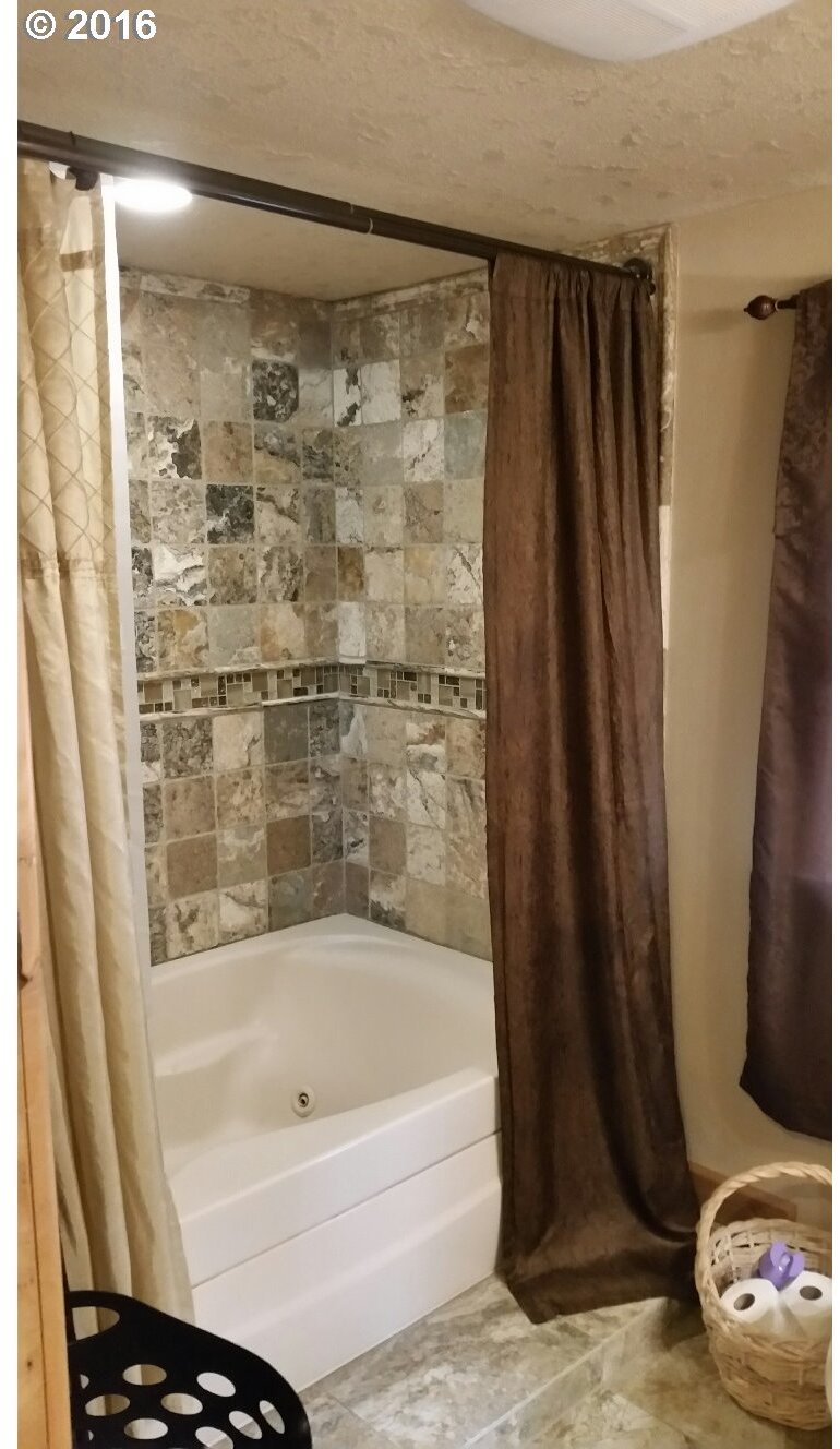 77862 North Ash Road Stanfield, OR 97875 - Photo 15 of 28 a bathroom with a bathtub and a shower