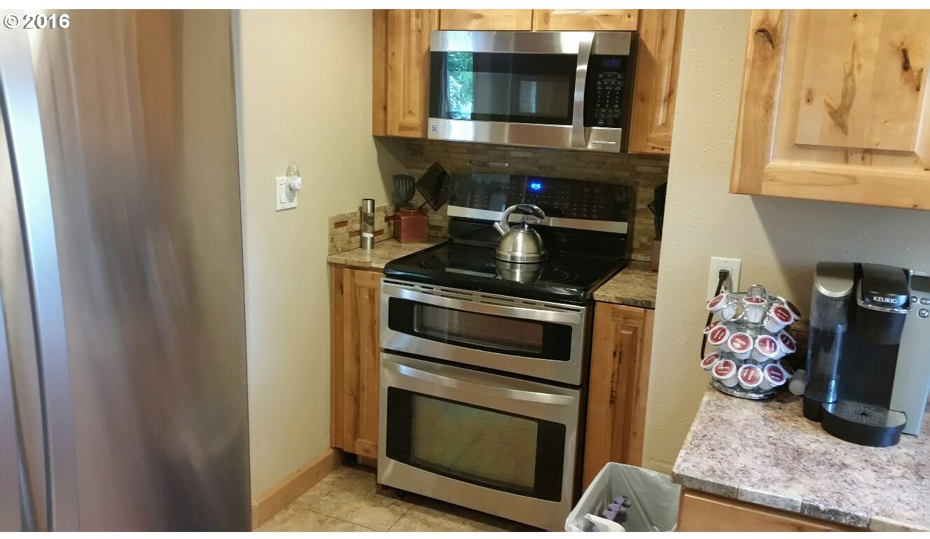 77862 North Ash Road Stanfield, OR 97875 - Photo 3 of 28 a kitchen with a stove and a microwave