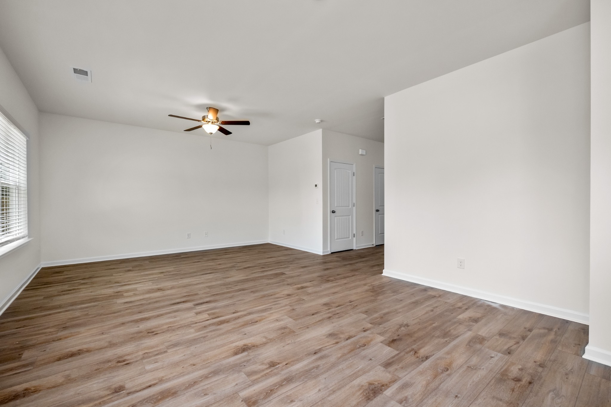106 Keystone Road Shelbyville, TN 37160 - Photo 12 of 33 a view of an empty room with wooden floor and a ceiling fan