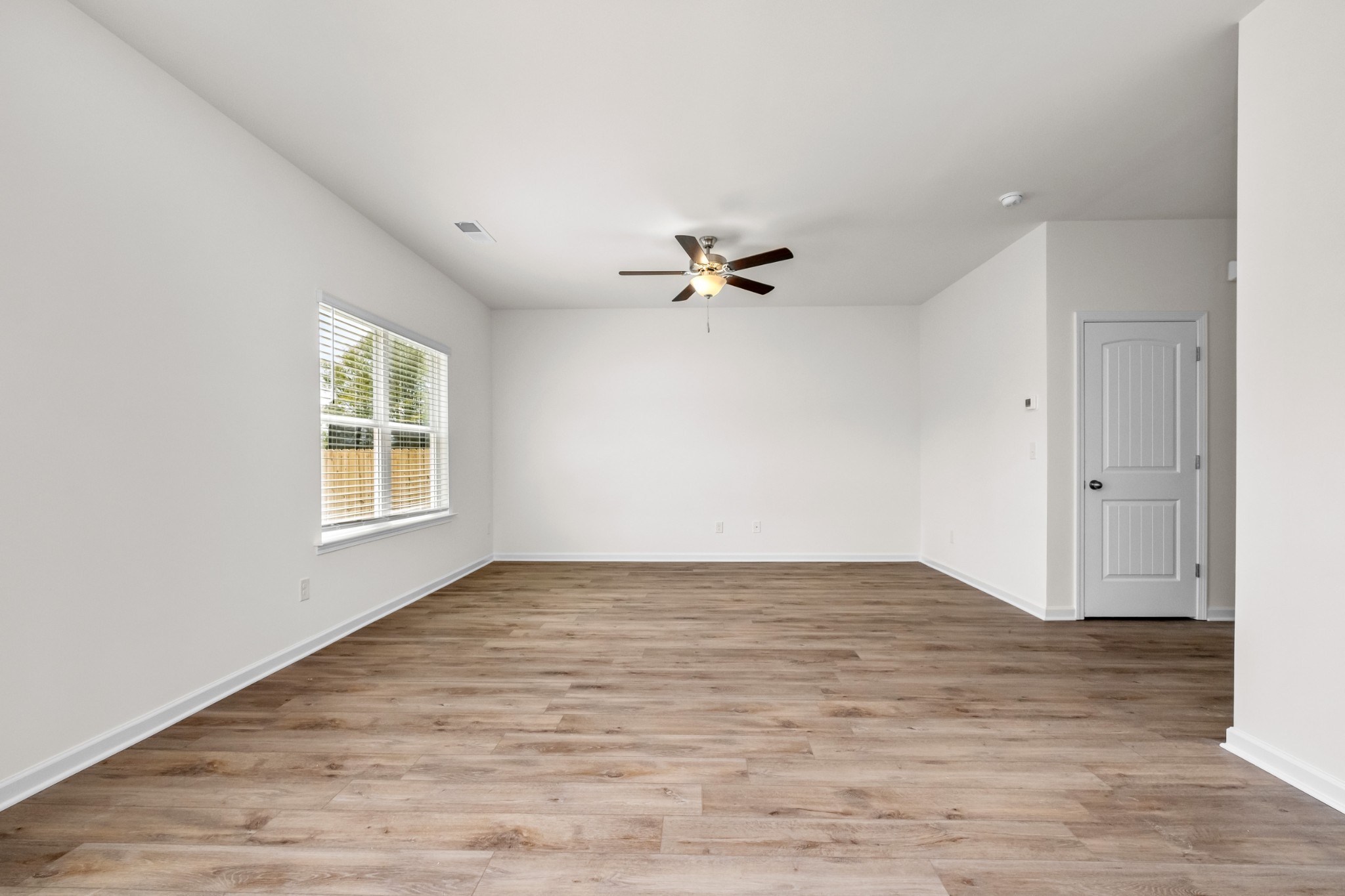 106 Keystone Road Shelbyville, TN 37160 - Photo 13 of 33 a view of a room with wooden floor and a ceiling fan