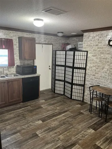 a view of a kitchen from the hallway