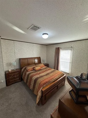 a bedroom with a bed and a mirror