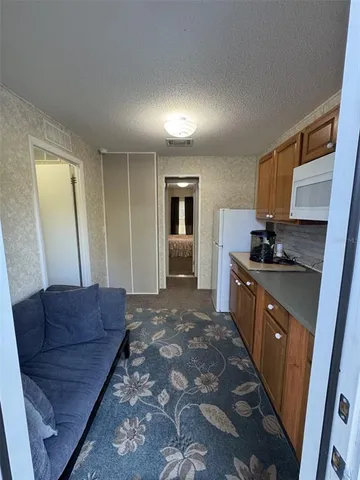 a kitchen with a stove a refrigerator and a sink