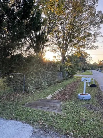 a view of a backyard with large trees