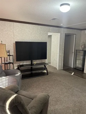 a view of a livingroom with furniture and a flat screen tv