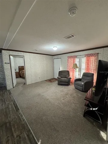 a kitchen with granite countertop wooden cabinets and a refrigerator