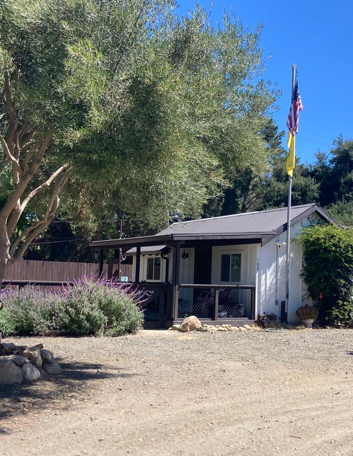 100 Den Street Los Alamos, CA 93440 - Photo 1 of 10 a front view of a house with a yard and potted plants