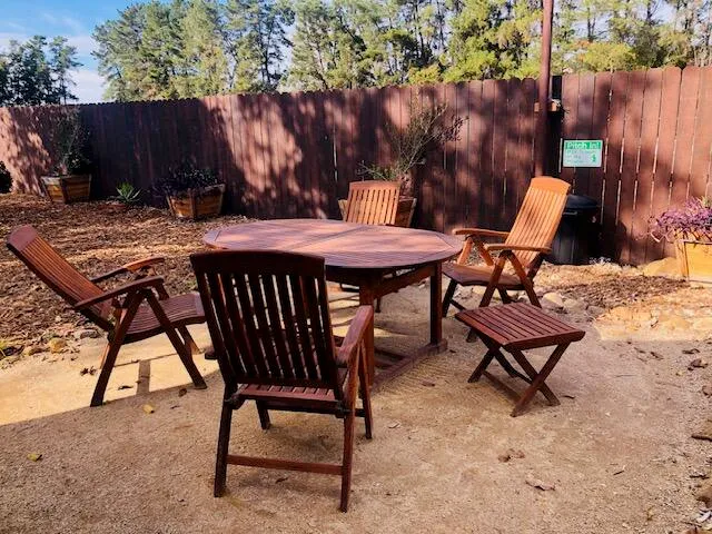 a backyard of a house with table and chairs