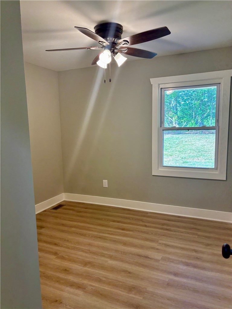 351 Randys Road Westminster, SC 29693 - Photo 19 of 30 Comfortable room with hardwood style flooring and an illuminating ceiling fan.