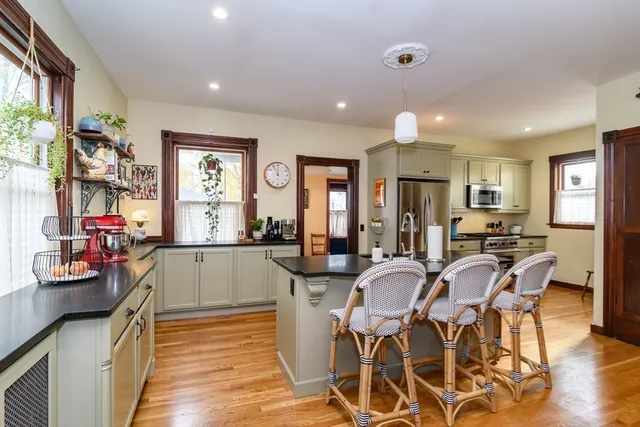 a view of a dining room with furniture and chandelier