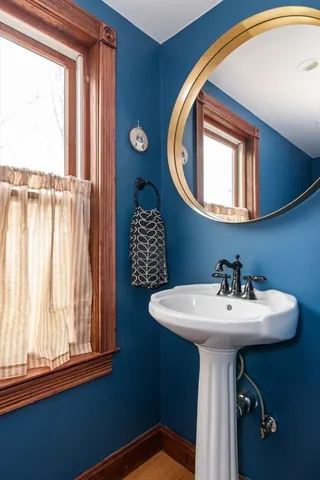 a bathroom with a sink a mirror and a window