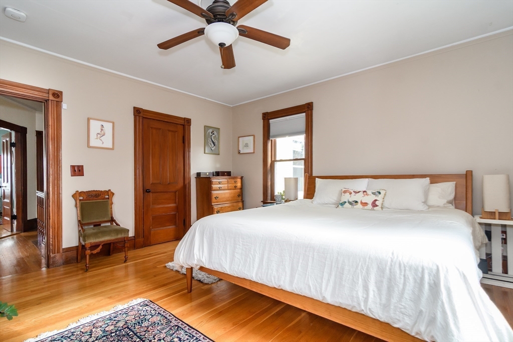 16 Alexander Street Framingham, MA 01702 - Photo 18 of 35 a bedroom with a bed a chair and a chandelier