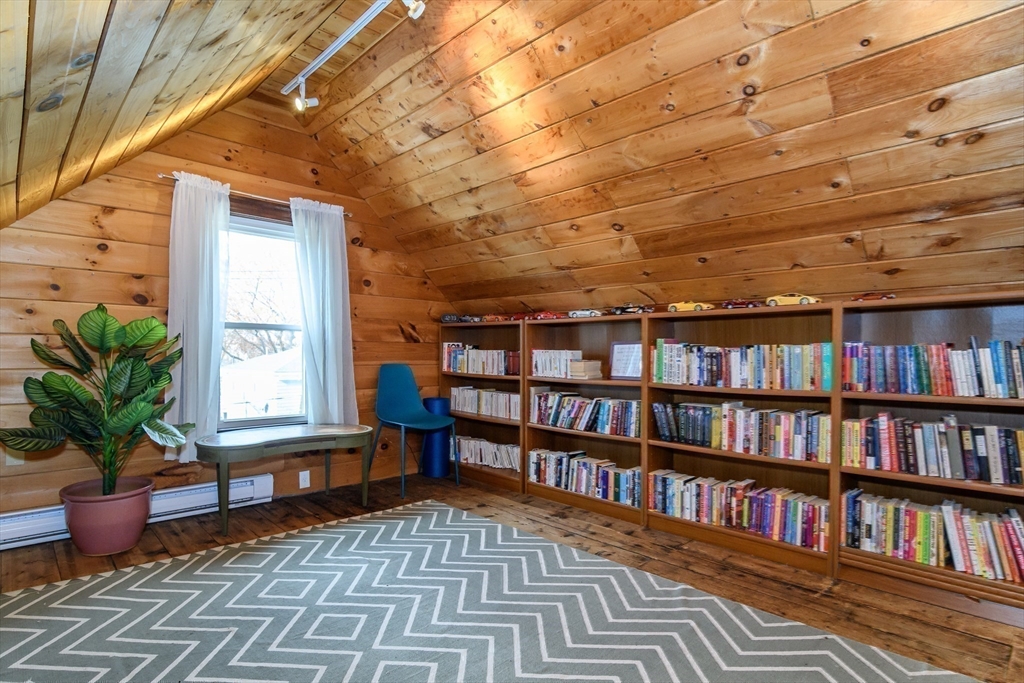 16 Alexander Street Framingham, MA 01702 - Photo 26 of 35 a living room with lots of books and a book shelf