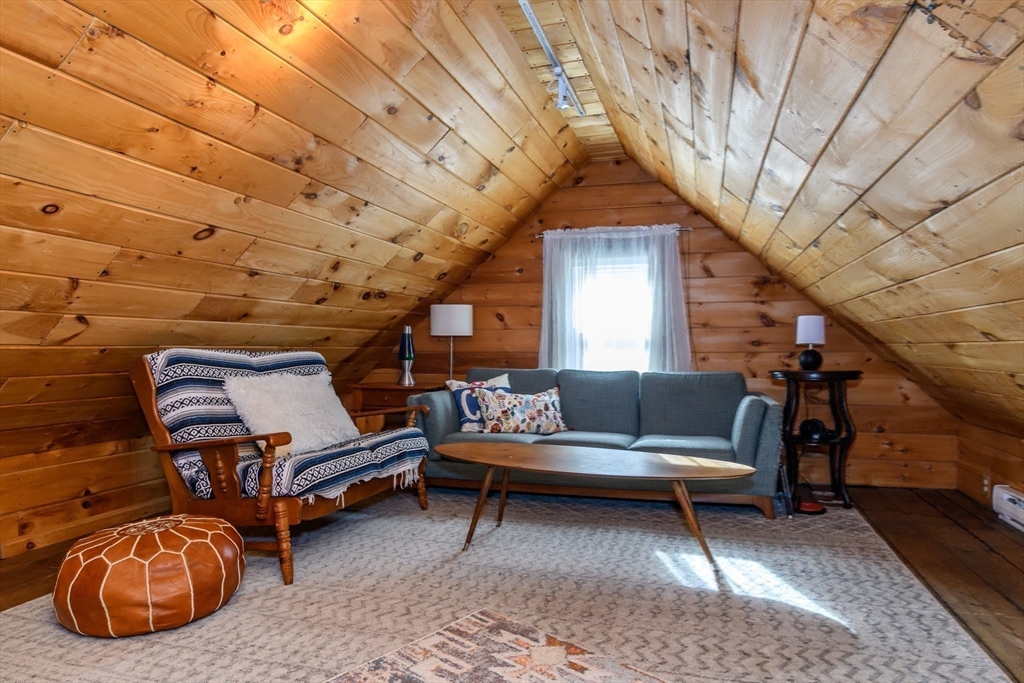 16 Alexander Street Framingham, MA 01702 - Photo 27 of 35 a living room with furniture a rug and a chandelier