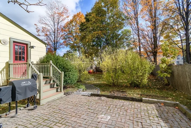 a view of a bench in the backyard of the house