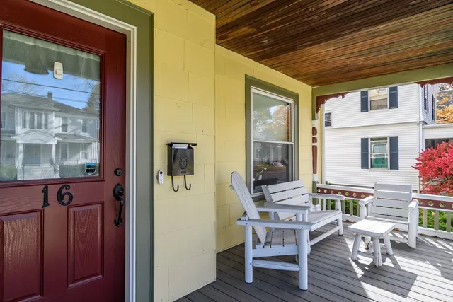 a balcony view with a dining table and chairs