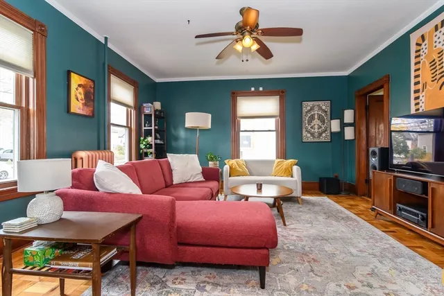 a bedroom with furniture and a large window