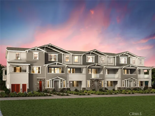 a front view of a residential apartment building with a yard