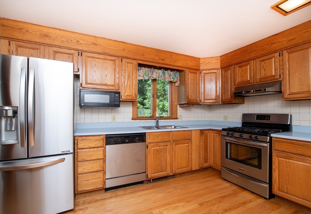 24 Ichabod Lane Marion, MA 02738 - Photo 11 of 35 a kitchen with stainless steel appliances granite countertop a refrigerator sink and stove