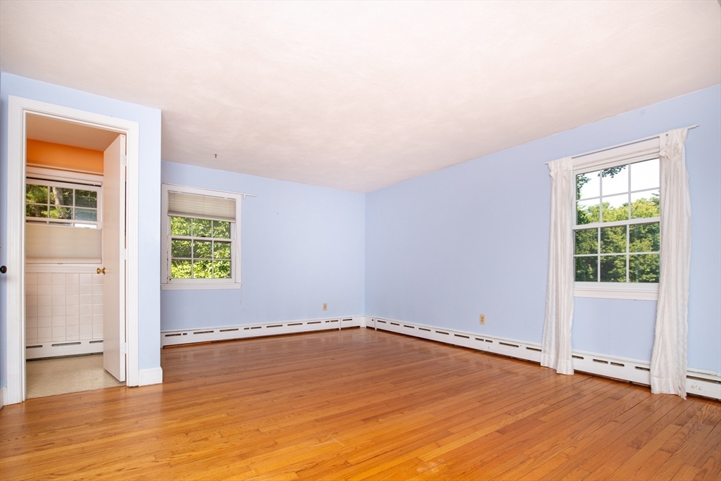 24 Ichabod Lane Marion, MA 02738 - Photo 21 of 35 an empty room with wooden floor and windows