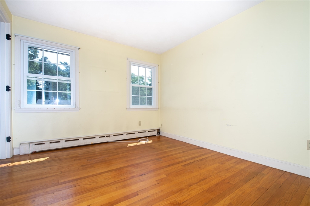24 Ichabod Lane Marion, MA 02738 - Photo 29 of 35 an empty room with wooden floor and windows