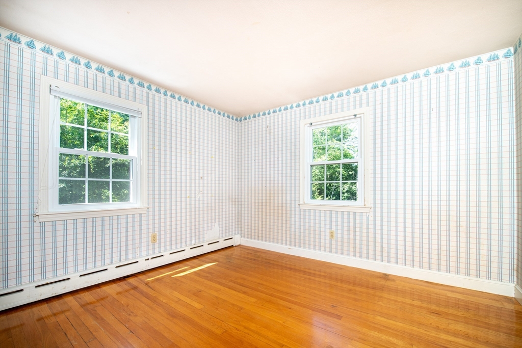24 Ichabod Lane Marion, MA 02738 - Photo 31 of 35 an empty room with wooden floor and windows
