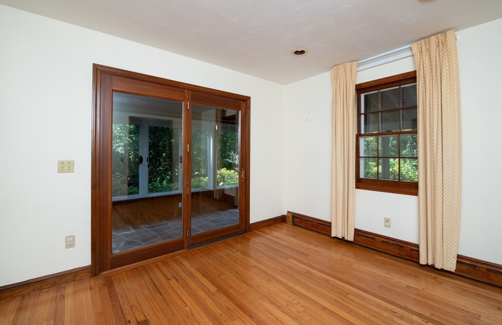 24 Ichabod Lane Marion, MA 02738 - Photo 9 of 35 an empty room with wooden floor and windows