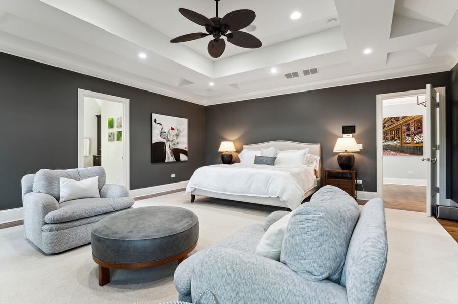 812 Hibbard Road Winnetka, IL 60093 - Photo 22 of 46 a bedroom with a bed couch chandelier and a window