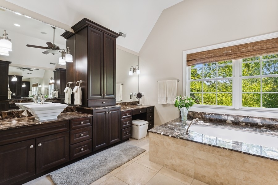 812 Hibbard Road Winnetka, IL 60093 - Photo 26 of 46 a large bathroom with a granite countertop tub and a sink