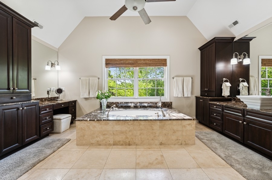 812 Hibbard Road Winnetka, IL 60093 - Photo 27 of 46 a large kitchen with kitchen island granite countertop a large counter top space appliances and a window