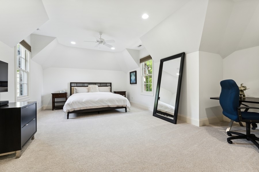 812 Hibbard Road Winnetka, IL 60093 - Photo 28 of 46 a bedroom with a bed and a chair