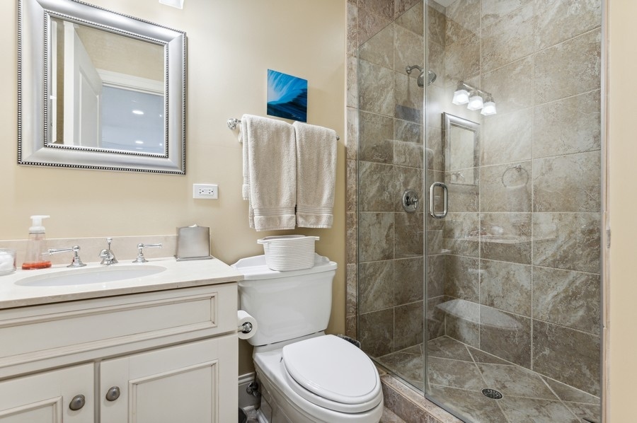 812 Hibbard Road Winnetka, IL 60093 - Photo 30 of 46 a bathroom with a sink a toilet and shower