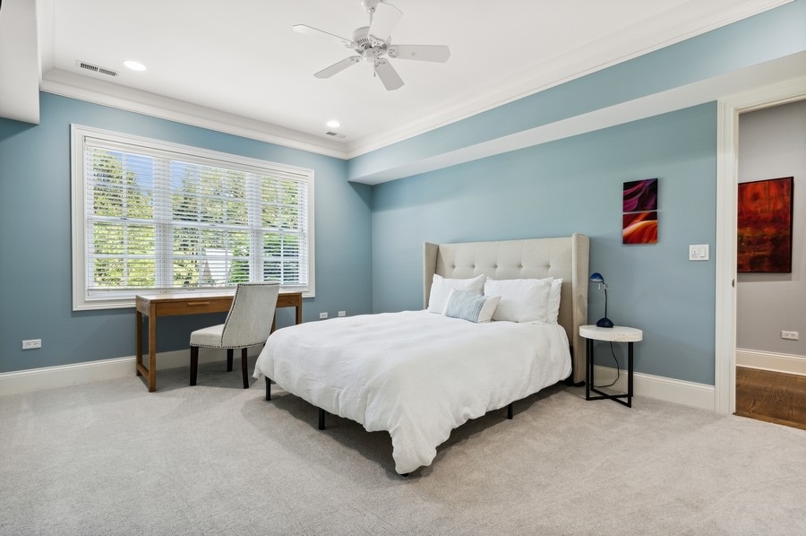 812 Hibbard Road Winnetka, IL 60093 - Photo 31 of 46 a large bed sitting in a bedroom next to a window