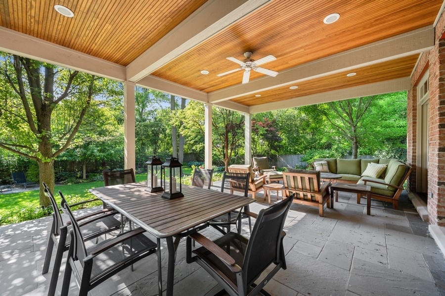812 Hibbard Road Winnetka, IL 60093 - Photo 39 of 46 a view of a patio with a table chairs and a backyard