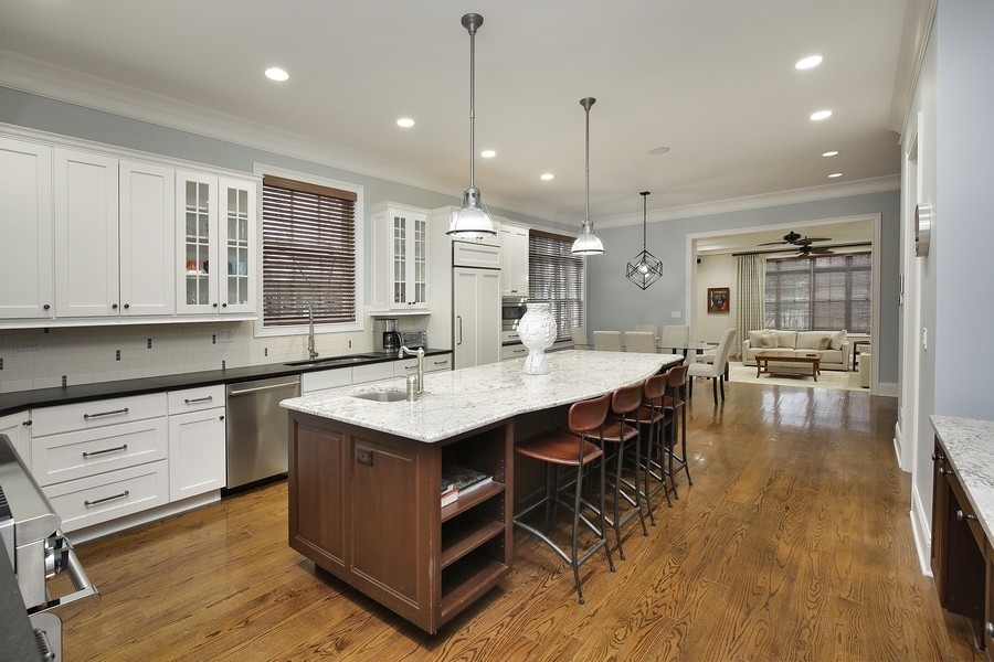 812 Hibbard Road Winnetka, IL 60093 - Photo 7 of 46 a large kitchen with kitchen island a island a sink a stove and a center island