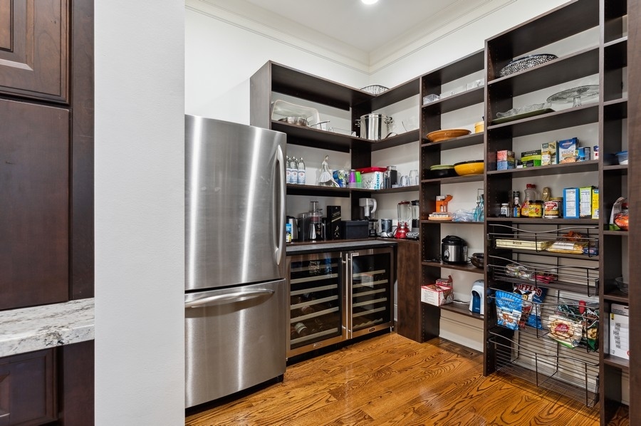 812 Hibbard Road Winnetka, IL 60093 - Photo 9 of 46 a kitchen with stainless steel appliances granite countertop a refrigerator and a stove top oven