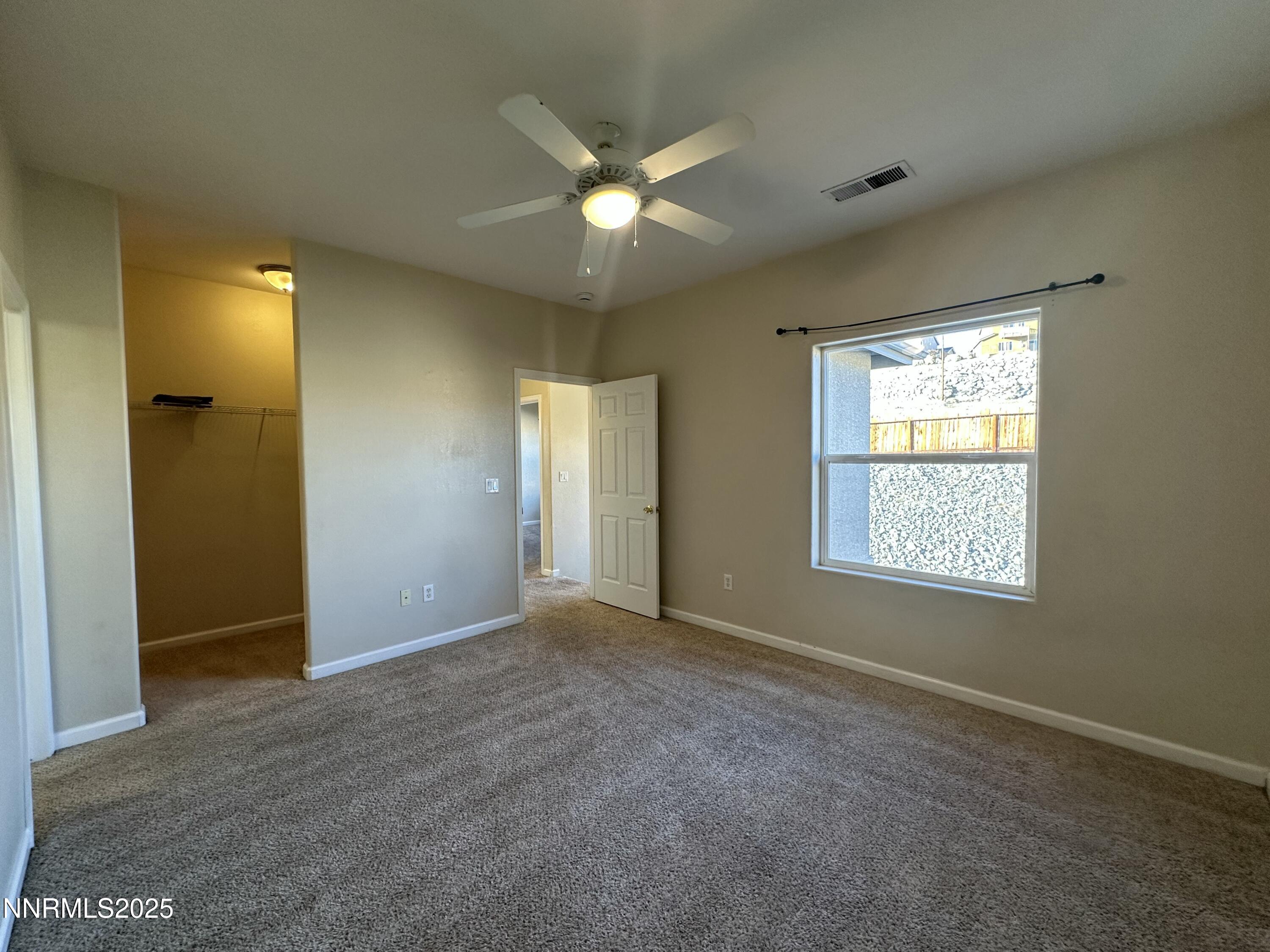 387 Orrcrest Drive Reno, NV 89506 - Photo 12 of 37 a view of an empty room with window and a ceiling fan