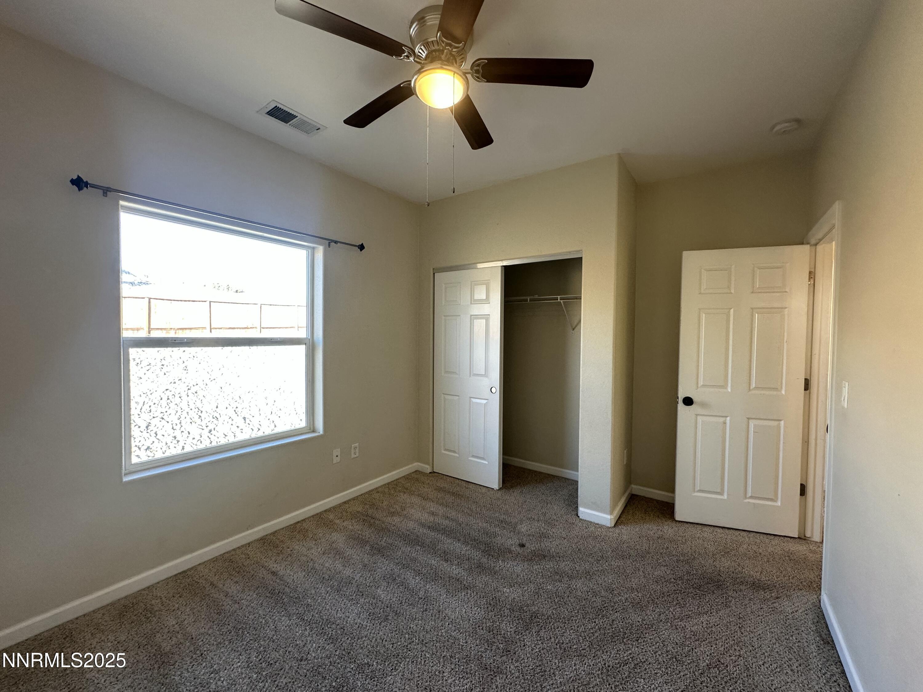 387 Orrcrest Drive Reno, NV 89506 - Photo 16 of 37 a view of empty room with window and chandelier fan