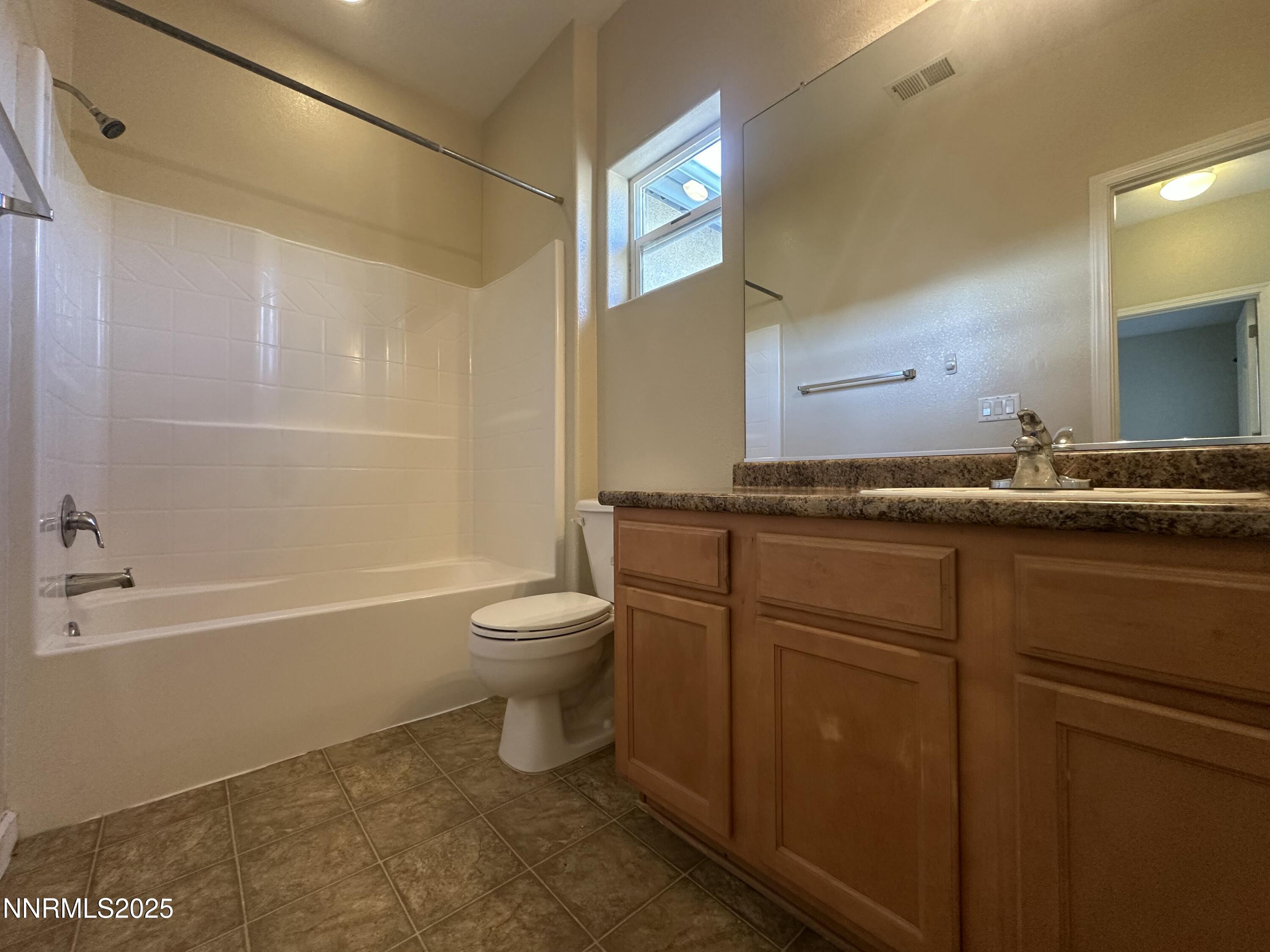 387 Orrcrest Drive Reno, NV 89506 - Photo 20 of 37 a bathroom with a granite countertop sink toilet and shower