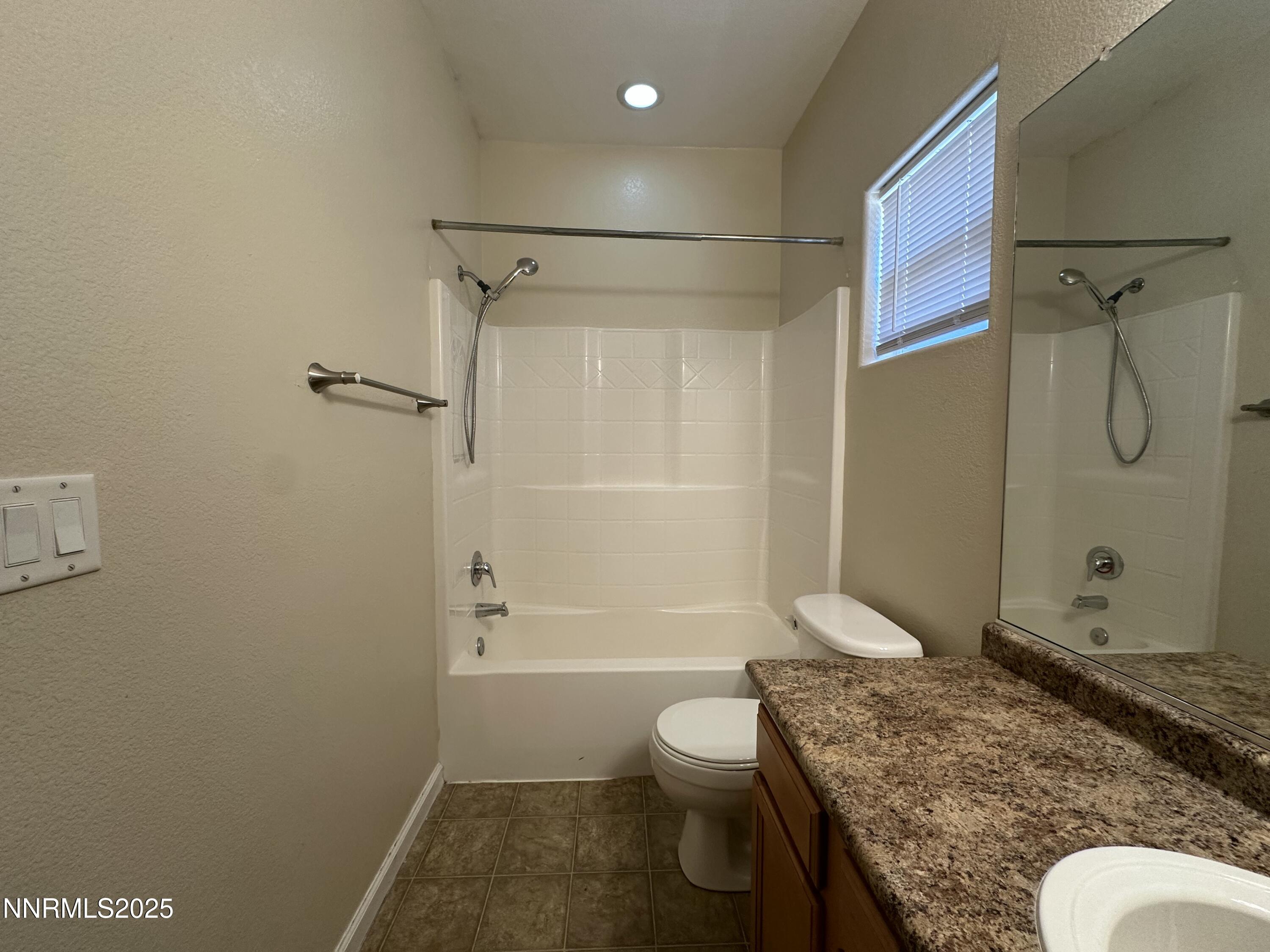 387 Orrcrest Drive Reno, NV 89506 - Photo 25 of 37 a bathroom with a granite countertop bathtub shower sink vanity and toilet