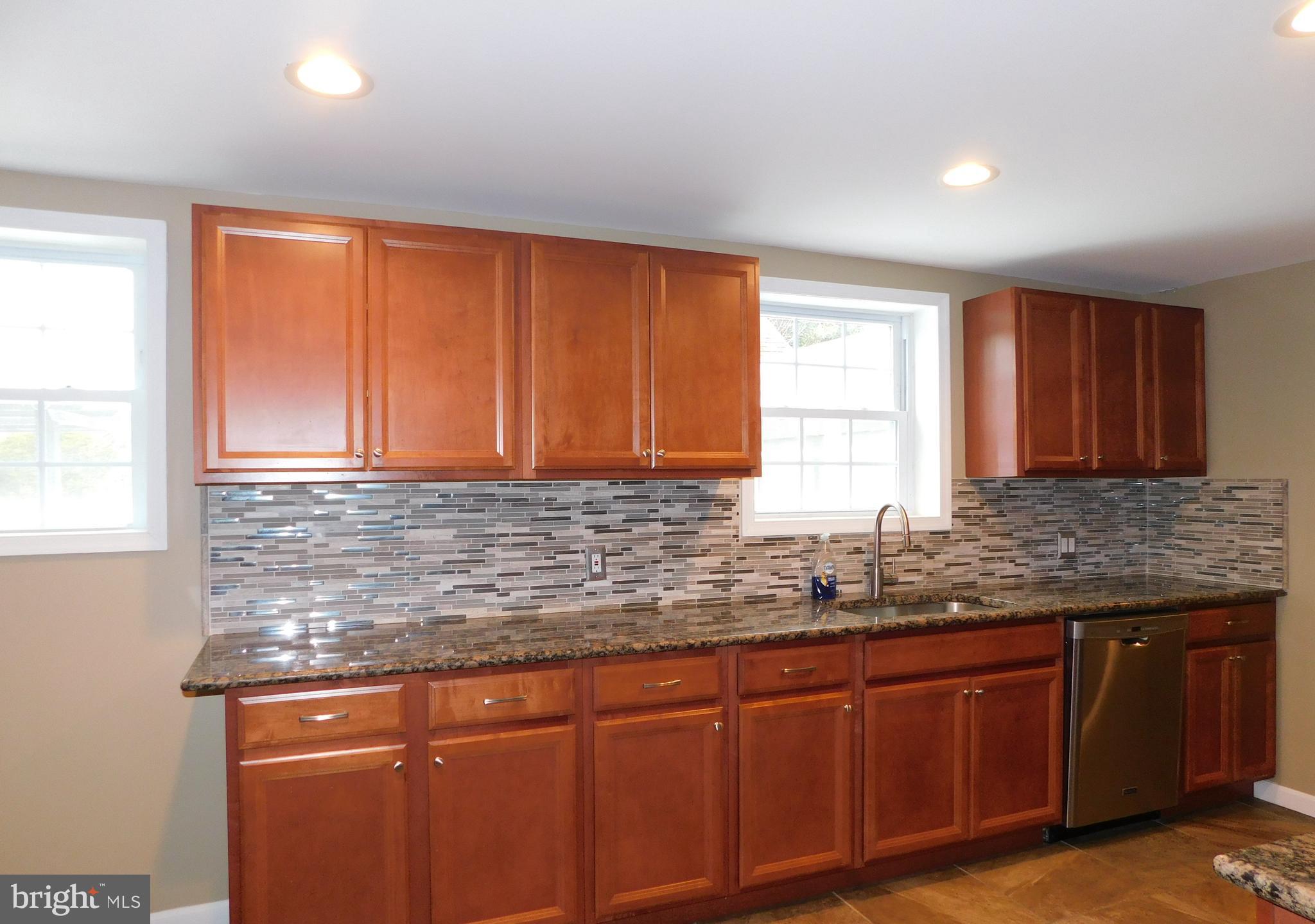 747 Churchville Road Southampton, PA 18966 - Photo 8 of 14 a kitchen with granite countertop wooden cabinets a sink and a window